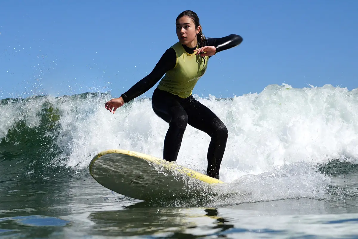 Surf lesson in A Coruña with beginner surfer riding a wave